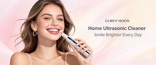 Smiling woman holding a white Curvymoon handheld tooth-cleaning device near her front teeth on a pink background.