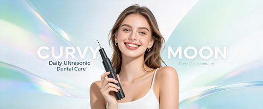 Smiling woman in a white top holding a black Curvymoon handheld dental cleaner against a pastel background.