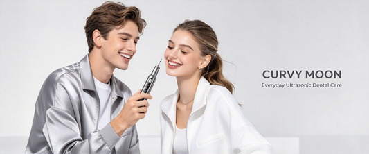 A smiling man holding a Curvymoon handheld dental cleaner beside a smiling woman.